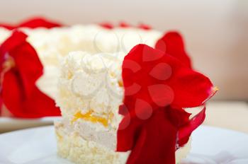 whipped cream mango cake with red rose petals 