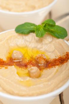 traditional chickpeas Hummus with mint olive oil and paprika on top 