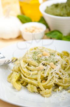 Italian traditional basil pesto pasta ingredients parmesan cheese pine nuts extra virgin olive oil garlic on a rustic table 
