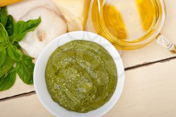 Italian traditional basil pesto sauce ingredients on a rustic table