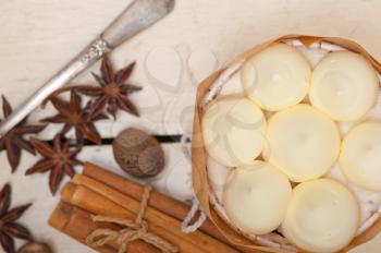 fresh vanilla and spice cream cake dessert over a rustic white wood table