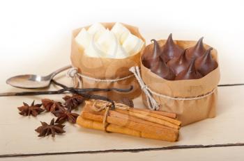 fresh baked chocolate vanilla and spices cream cake dessert over rustic wood table 