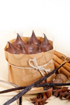 fresh baked chocolate vanilla and spices cream cake dessert over rustic wood table