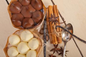 fresh baked chocolate vanilla and spices cream cake dessert over rustic wood table 