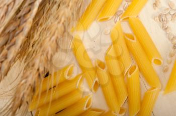 short Italian pasta penne with durum wheat grains