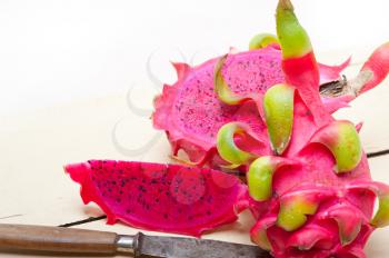 fresh thai purple dragon fruit over white rustic table