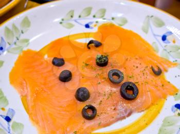 Norwegian smoked salmon with black olives on top