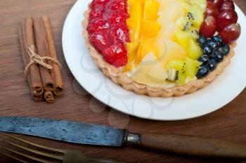 fresh homemade fruits cake pie over wood cutting board