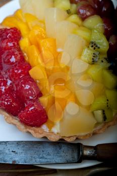 fresh homemade fruits cake pie over wood cutting board