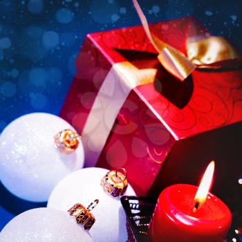 Christmas background with candle and decorations on blue