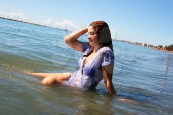 Royalty Free Photo of a Woman Sitting in the Sea