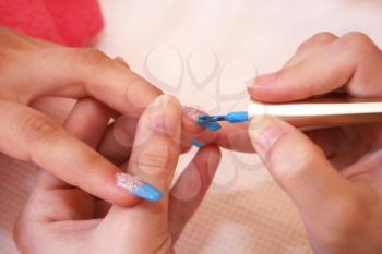 Royalty Free Photo of a Woman Getting a Manicure