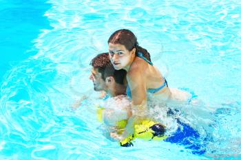 Royalty Free Photo of a Couple Having Fun in a Swimming Pool