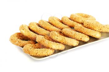 Round rusks with sesame seeads on tray.
