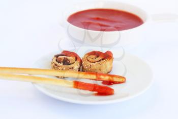Rusks with sesame seeds, bread sticks and red sauce isolated on gray  background.