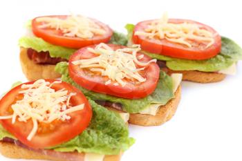 Sandwiches with bacon, lettuce, tomato and cheese.
