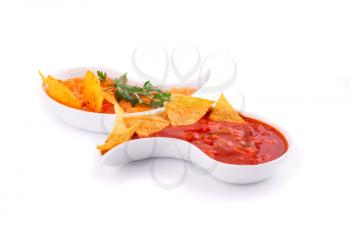 Nachos,  cheese and red sauce isolated on white background.