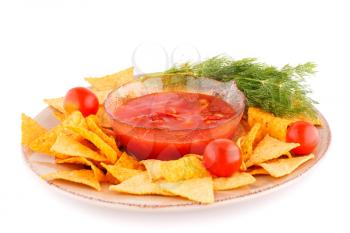 Nachos, cherry tomato, dill on plate and red sauce isolated on white background.