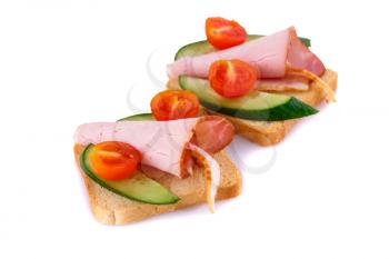 Rusk sandwiches with tomato, cucumber and pork loin isolated on white background.