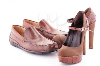 Two pair of brown shoes isolated on white background.