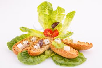 Rusks, feta cheese and vegetables isolated on white background.