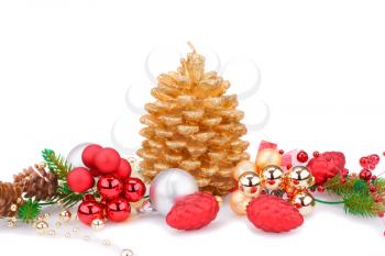 Christmas candle, balls and  fir tree branches isolated on white background.
