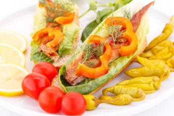 Smoked fish with fresh vegetables on plate.