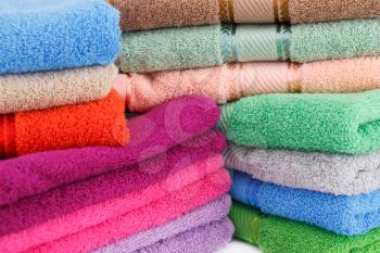 Colorful towels stacks closeup picture.
