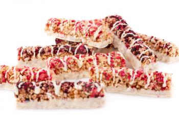 Cereal bars with different berries and seeds isolated on white background.