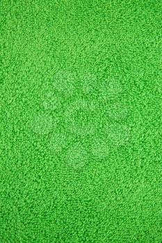 Green towel texture as a background, closeup picture.