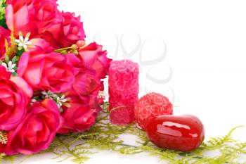 Candles, roses and glass heart  isolated on white background.