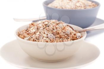 Muesli in the bowls on white background.