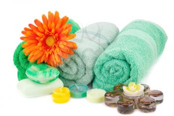 Spa set with towels, candles, soaps and flower isolated on white background.