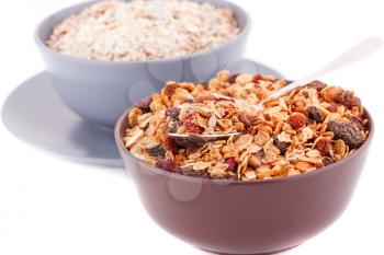 Muesli in the bowls isolated on white background.