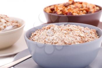 Muesli in the bowls on white background.