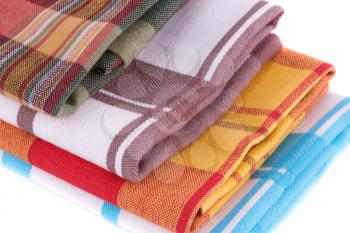 Stack of colorful kitchen towels on white background.