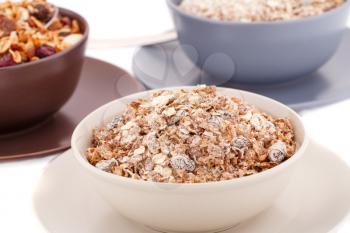 Muesli in the bowls on white background.