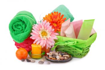 Spa set with towels, creams, lotions, candles, stones and flowers isolated on white background.