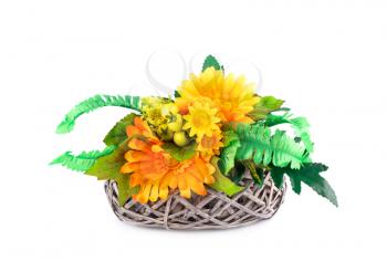 Fabric daisies in wicker basket isolated on white background.