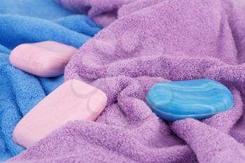 Colorful towels and soaps closeup picture.