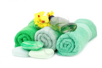 Spa set with towels, lotion, soaps and orchid flowers isolated on white background.