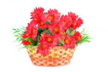 Red fabric flowers in wicker basket isolated on white background.
