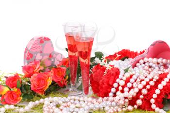 Two glasses, flowers, colorful pearls necklaces and gift box on white background.