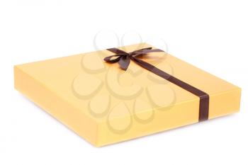 Yellow chocolate box with brown ribbon isolated on white background.