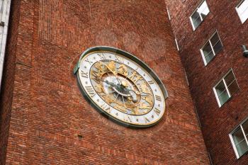 Clock on the wall of City hall in Oslo, Norway.