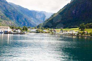 Landscape with Naeroyfjord, mountains and traditional village houses in Norway.