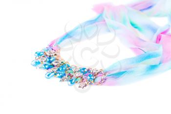 Stylish necklace with colorful ribbon and stones isolated on white background.