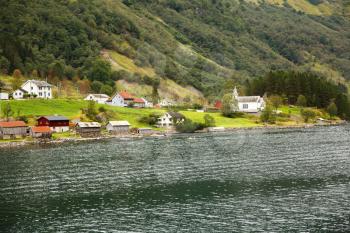 Landscape with Naeroyfjord, mountains and traditional village houses in Norway.