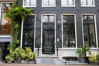 Traditional old building with plants in Amsterdam, Netherlands.