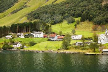 Landscape with Naeroyfjord, mountains and traditional village houses in Norway.